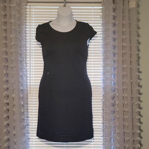 Little black dress with beaded detail around neck and bottom.